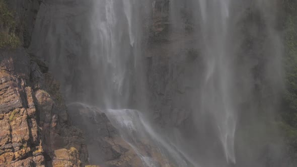 Wonderful Large Waterfall Streams Fall on Brown Rocky Cliff