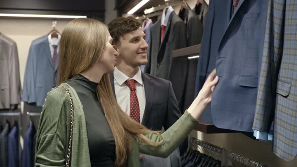 Woman and Man Choosing Jacket in Store