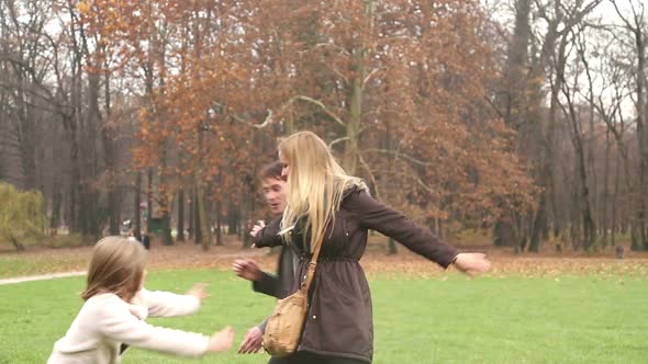Girl playing with her parents in park