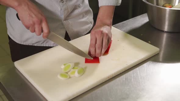 Chef Is Chopping a Red Paprika for Meal for Dinner on a Table