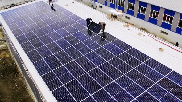 Solar Technician Installing Solar Panels on House Roof