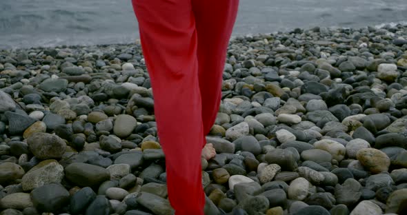 Barefoot Lady Walks Along Grey Pebble Beach at Endless Sea