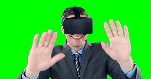 Happy businessman using virtual reality headset