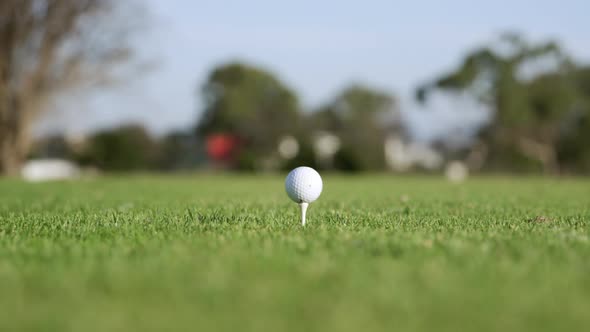 Golf player hitting the ball with his club