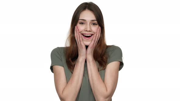 Portrait of Caucasian Woman Expressing Unexpectedness and Surprise Emotionally Covering Face with