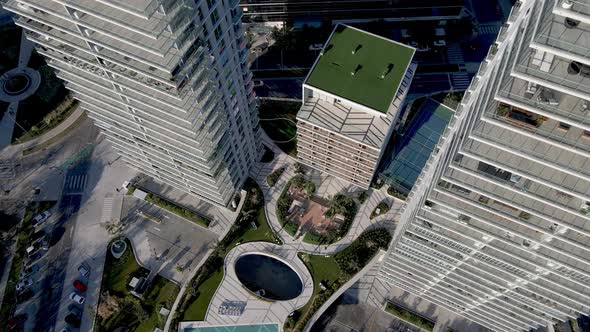 Descending drone footage close to high-rise apartment towers in Puerto Madero, Buenos Aires. Aerial