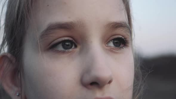 Profile of Young Girl Looking Up at Sunset Sky