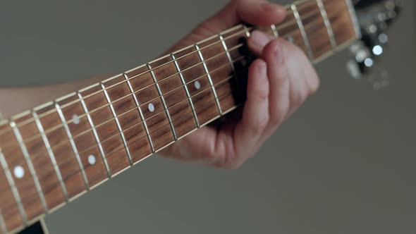 Closeup Guitarist Plays on Guitar on White Background