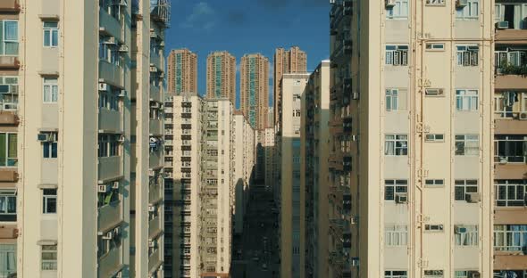 Urban Cityscape. The Drone go Down Between Tall Apartment Blocks