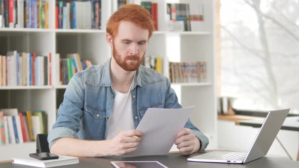 Casual Redhead Man Reading Documents, Contract