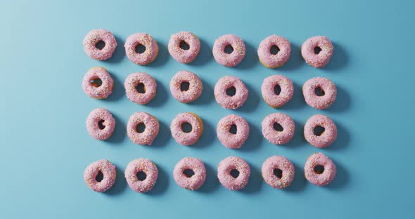 Video of donuts with icing on blue background