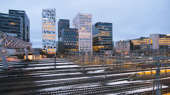 Train Leaving Oslo Central Station With Barcode Project Buildings At Night In Bjorvika, Oslo, Norway