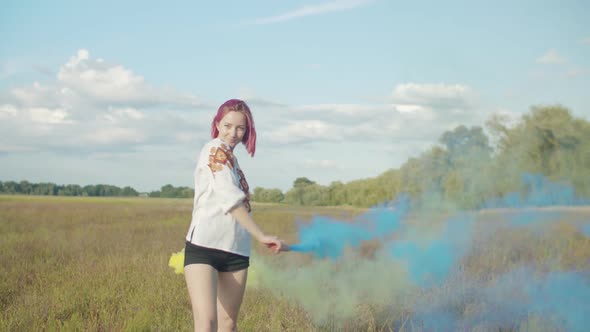 Joyful Woman with Colored Smoke Bombs Outdoors