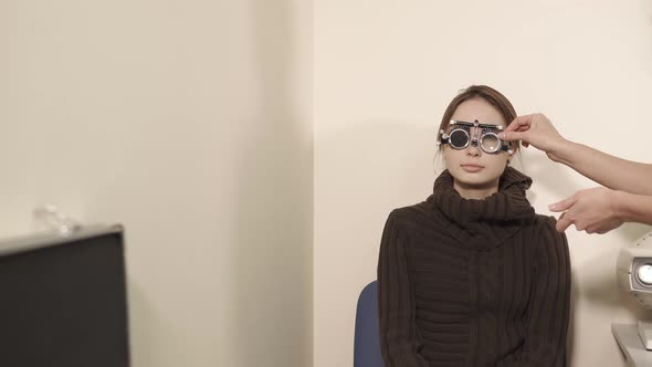 Portrait of a Teenager a Doctor Changing Lenses on Glasses for Visionimetry