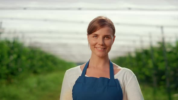 Woman Entrepreneur Looking Camera at Sunny Modern Green House