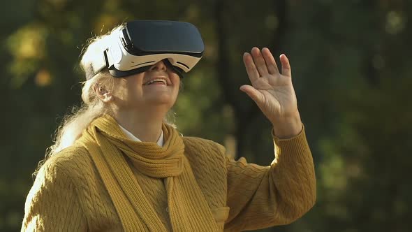 Old Woman Using VR Headset, Exploring Virtual World, Modern Entertainment