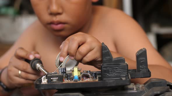 Asian Boy Fixing Motherboard