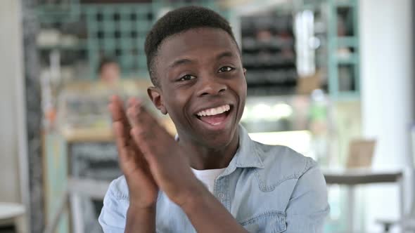 Portrait of Appreciating Young African Man Clapping Cheering
