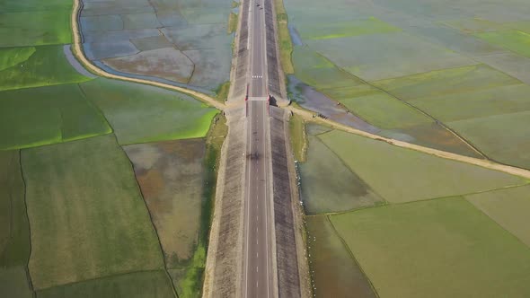 Aerial view of a road among the fields in Sapahar, Rajshahi, Bangladesh.