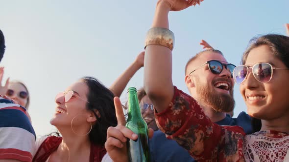 Young people dancing together during the summer party 