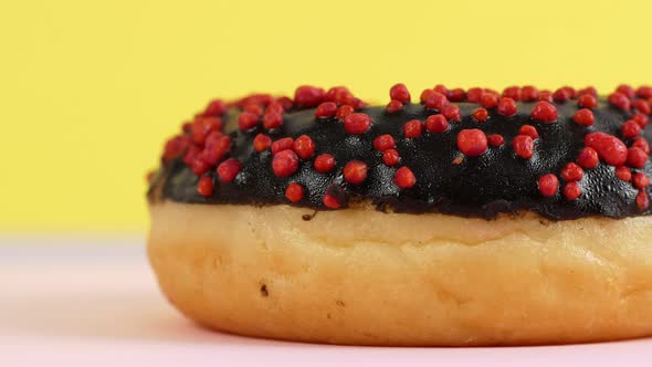 Close-up slider motion donuts. 4k closeup of delicious sweet multicolored donuts on colorful back