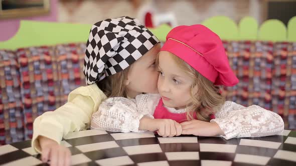 Two sisters in the head cooking hat. Homemade pastry and cooking.