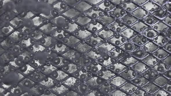 The Flow of Water Directed to the Metal Mesh Causes the Bubbling of Oxygen Bubbles