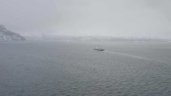 Ferry Boat From Olderdalen Cruising To Lyngseidet On A Foggy Winter Day In Norway. - aerial