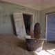 A Naked Young Woman in an Abandoned Building Sits with Her Back in the Bath Tub - VideoHive Item for Sale