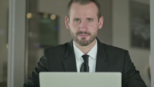 Close Up of Handsome Businessman Showing Thumbs Up at Night