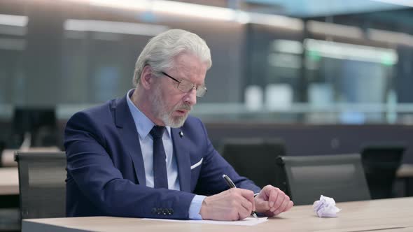 Old Businessman Having Failure Writing on Paper