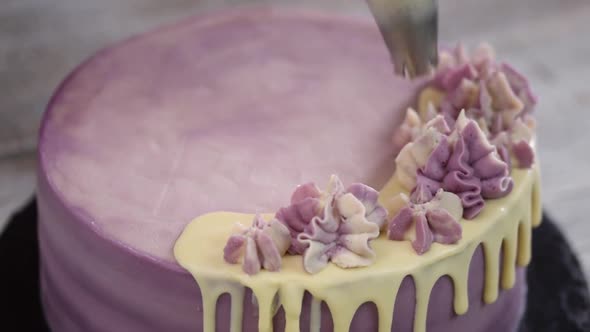 Chef Decorating Cake with a cream.	