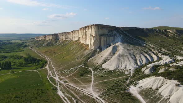 White Vertical Rocky Wall Rising Above the Valley