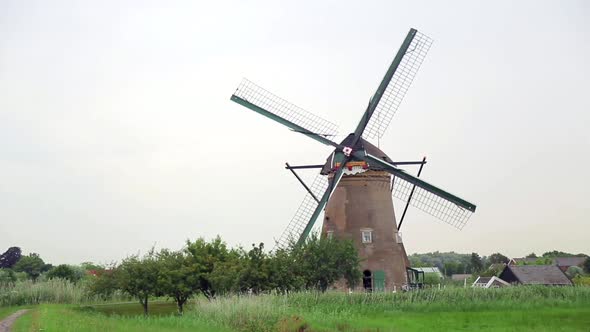 The Sails of the Mill Almost Touch the Ground As They Turn