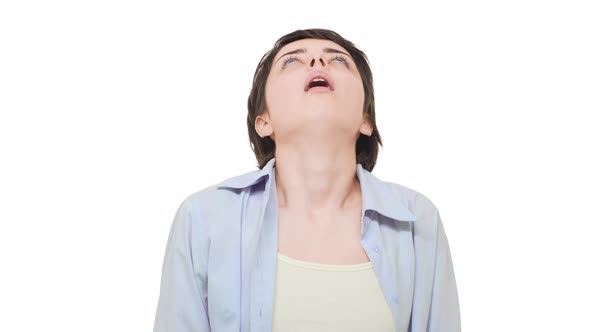 Young Tired Caucasian Female with Short Hait Sighin Heavily Over White Background and Doing Double