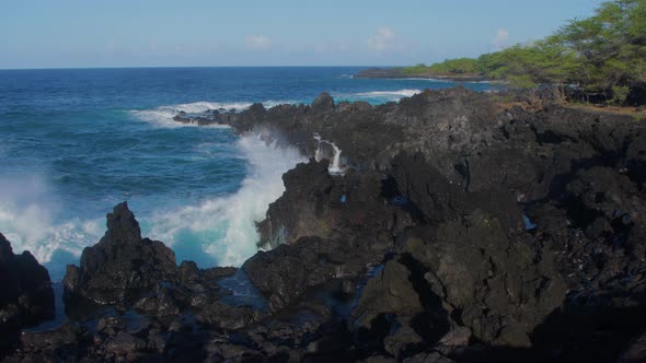 Waves crashing into shore on Hawaii