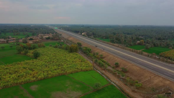 Aerial View Of New Motorway Through Farming Countryside In Sindh With Hardly No Traffic