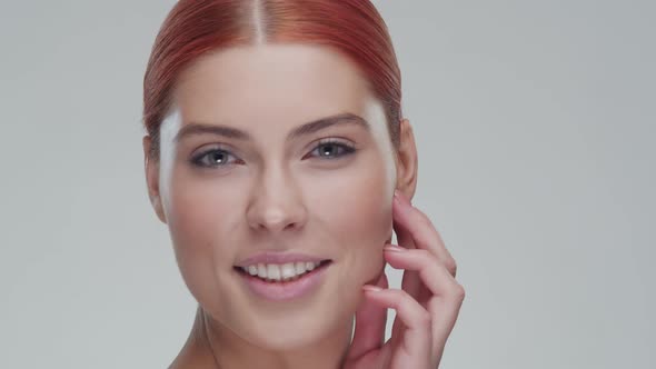 Studio portrait of young, beautiful and natural redhead woman. Beauty concept.