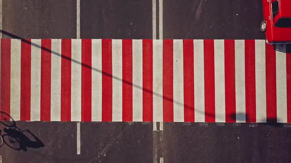 Road surface marking with red and white stripes and the cars driving on it