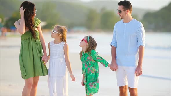 Happy Beautiful Family on a Beach During Summer Vacation