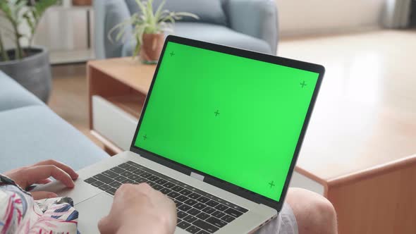 Close Up Man Using Laptop Computer With Green Screen At Living Room