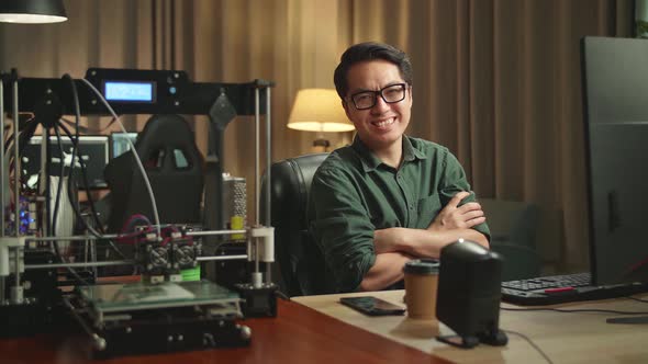 Asian Man Pose While Works On Personal Computer And 3D Printer In Home Office