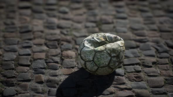 Old Soccer Ball in the Pavement Yard alt