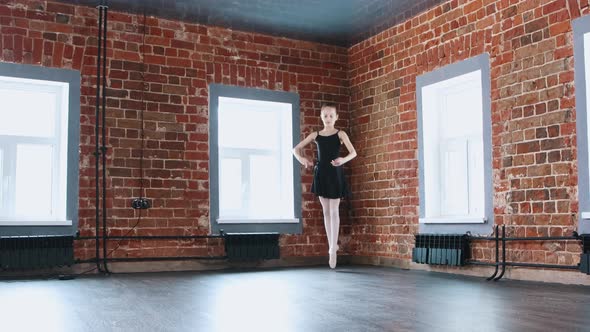 Ballet Dancing Indoors  a Little Gymnastics Girl Dancing in Black Suit From the Corner of the Studio