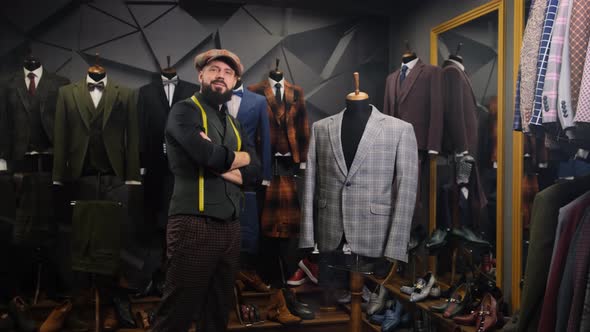 Bearded Tailor Portrait. Handmade Costume Designer Poses Near a Mannequin in a Tailor Store. Fashion