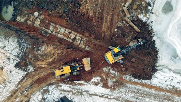 Heavy Machinery at a Construction Site. Industrial Tractors, Excavators Work at a Career with Sand