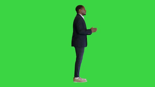 Young Black Businessman Speaking To the Camera on a Green Screen Chroma Key