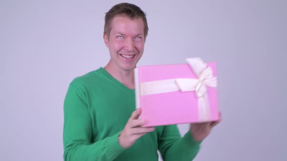 Happy Young Excited Man Dancing with Gift Box Ready for Valentine's Day