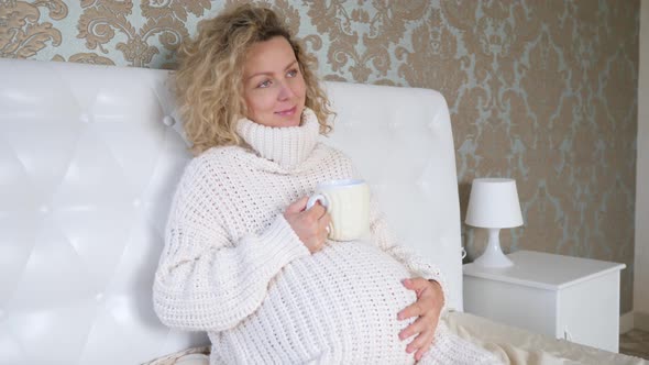 Happy Pregnancy, Lifestyle Of Pregnant Woman In Knitted Sweater Resting In Cozy Bed