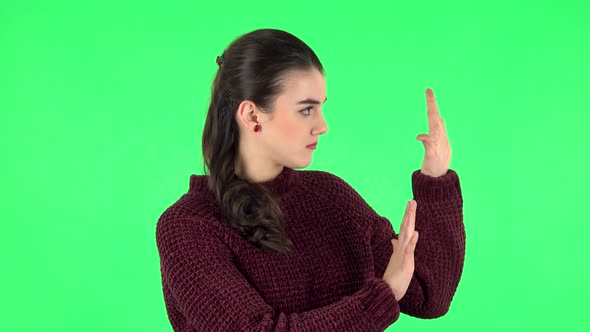 Woman Strictly Gesturing with Hands Shape Meaning Denial Saying NO. Green Screen
